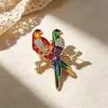 Elegant colorful parrot brooch featuring shiny rhinestones and enamel on a gold-tone branch - Red Double Parrot Enamel Style (YNCP1538 Red)