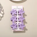 Set of 6 purple plumeria flower hair claw clips displayed on a pink professional card - 4cm Frangipani Style / 6-Piece Set (Bulk) / Purple