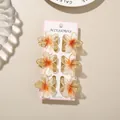 Set of 6 gradient orange plumeria flower hair clips on a display card for elegant styling. - Glitter Frangipani Style / 6-Piece Set (4cm) / Glitter Orange / Bulk Packaging