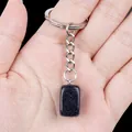 Natural blue goldstone rectangular gemstone keychain pendant displayed in a person's hand - Blue Sandstone (Artificial)