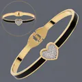 Elegant 18K gold plated stainless steel heart bangle featuring black enamel and pavé crystals. - Black Heart Enamel (BS-J5645GBLK)