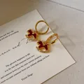 Elegant micro-set red rocking horse hoop earrings with gold finish and crystal details - Red Rocking Horse / Gold/Red