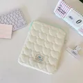 Close-up detail of soft quilted heart pattern on cream laptop sleeve with green zipper - White Heart