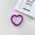 Close-up of heart-shaped purple silicone phone grip featuring a centered mirror - Dark Purple
