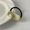 Gold geometric textured metal hair tie featuring a black elastic band for elegant styling - Wide Single-Row Diamond Pattern