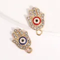 Goldene Hamsa-Hand-Anhänger mit Strassrand und bunten Emaille-Böse-Augen-Zentren - Rote und blaue Hamsa-Hand des bösen Blicks / Silber