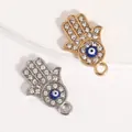 Hamsa-Hand-Anhänger mit bösem Blick und Strasssteinen in Gold- und Silber-Optik - Hamsa-Hand mit blauem Auge und Strass-Pave / Silber