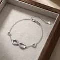 Elegant S925 sterling silver infinity symbol bracelet with hollow heart charms for women - 925 Silver / White Gold Color (815SL)