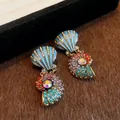 Close-up of vintage palace style shell earrings decorated with colorful rhinestones - Multicolor Sea Element Earrings (Silver Earring Post)