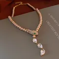 Close-up detail of vintage palace style necklace featuring rhinestone snake head and pearls - Gold Champagne Pearl Snake Head Necklace