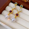 Close-up of elegant vintage palace style gold drop earrings with pearls and gems - Gold Blue White Red Drop Earrings (Silver Earring Post)