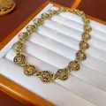 Detailed view of a vintage gold-toned lion head statement necklace on a jewelry tray - Gold Lion Head Choker Chain