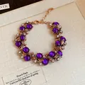 Elegant vintage palace style bracelet featuring purple beads and sparkling crystal accents - Golden Purple Bracelet