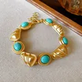 Vintage gold palace style bracelet with turquoise stones and textured shell metal - Gold Teal Faux Turquoise Bracelet