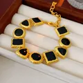 Vintage court style bracelet featuring gold textured geometric charms with black inlays - Gold Black Geometric Bracelet