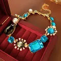 Vintage palace style necklace with blue crystals and pearls in a red jewelry box - Gold Blue Gray Irregular Gem Necklace
