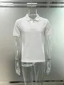 Detailed view of a men's white jacquard polo shirt with textured diamond patterns. - S / White