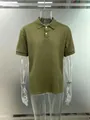 Detail of men's olive green jacquard polo shirt with button placket and ribbed collar. - S / Olive Green