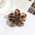 Large floral shaped translucent amber hair claw clip for elegant styling - Flower