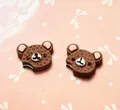 Close-up of bear-shaped chocolate cake resin accessories for DIY phone cases and hair clips - Coffee