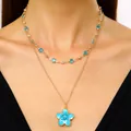 Close-up view of a layered gold necklace set featuring a vibrant blue enamel flower pendant. - Single-layer Clavicle Chain / Blue (K-831)
