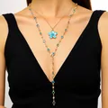Detail shot of a layered gold necklace featuring a blue enamel flower and crystal accents - Double Layer Clavicle Chain / Blue (K-766)