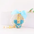 Elegante llavero de cristal azul con forma de corazón, lazo de cinta celeste y detalles de perlas - Estilo Botella Perfume Corazón / Peso 56,6 g, Longitud 11,6 * 3,9 cm / Azul