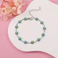 Detail view of a dainty blue and yellow daisy flower chain bracelet on white display - Sky Blue Daisy (Silver Tone)
