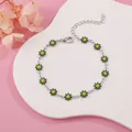 Close-up of silver-tone chain bracelet with green and yellow enamel daisy charms. - Green Daisy (Silver Tone)