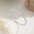 Detailed macro shot of a silver petal zircon bangle featuring elegant sparkling stone accents. - Style C Silver