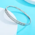Close-up of silver-tone bangle with intricate petal patterns and pavé zirconia stones. - Style H Silver