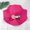 Vibrant pink wide-brimmed straw hat decorated with colorful fabric flowers and a bow. - M (56-58cm) / Rose Red