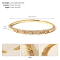 Elegant gold-plated open bangle bracelet with zircon stones and criss-cross X details - Style D Gold