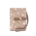 Detail of a floral print women's short wallet with wristlet and leaf buckle detail - Apricot
