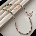 Detailed view of rainbow natural stone necklace with freshwater pearls and gold beads. - Necklace Style