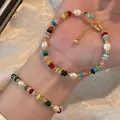 Detailed close-up showing rainbow natural stone beads and rice freshwater pearls on a bracelet - Bracelet Style