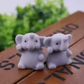 Pair of cute grey elephant TPR squishy stress relief toys shown on wooden surface - Elephant Gray
