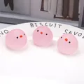Three pink bird-shaped TPR squishy stress relief toys on a white plate - Pink Chicken Head