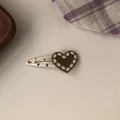 Detail of a white heart-shaped BB hair clip with colorful dots and "LOVE" text. - Brown Heart BB Clip