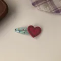 Close-up detail of a sweet pink heart hair clip with embossed LOVE text and dots - Rose Red Heart BB Clip