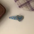 Close-up of cute blue heart hair clip with colorful dots and LOVE text decoration - Light Blue Heart BB Clip