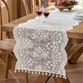 Elegant white French lace table runner with hollow floral patterns and pompom fringe - Daisi White