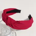 Elegant red wide-sided knotted fabric headband featuring a stylish cross-knot design - Solid Red