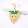 Detailed view of a leather strawberry keychain with gold studs and a metallic clasp - Punk Metal Stud Strawberry / Khaki