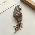 Vintage colorful rhinestone parrot brooch encrusted with sparkling multi-color crystals - Champagne