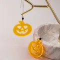 Vibrant Halloween yellow acrylic pumpkin earrings with heart eyes on stand - Heart-eye Yellow Pumpkin