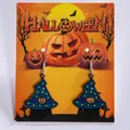 Blue Halloween witch hat drop earrings with yellow stars and pumpkin design on display card - Blue Wizard Hat with Moon & Star