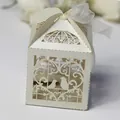 Close-up detail of an elegant laser-cut bird favor box with a delicate white ribbon - 5*5*8CM / Ivory