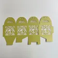 Flat-lay view of golden laser-cut wedding favor box with romantic bird cage patterns - 5*5*8CM / Yellow-Green