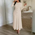 Elegant long-sleeved cream textured maxi dress featuring decorative buttons and a fishtail hem - S / Apricot